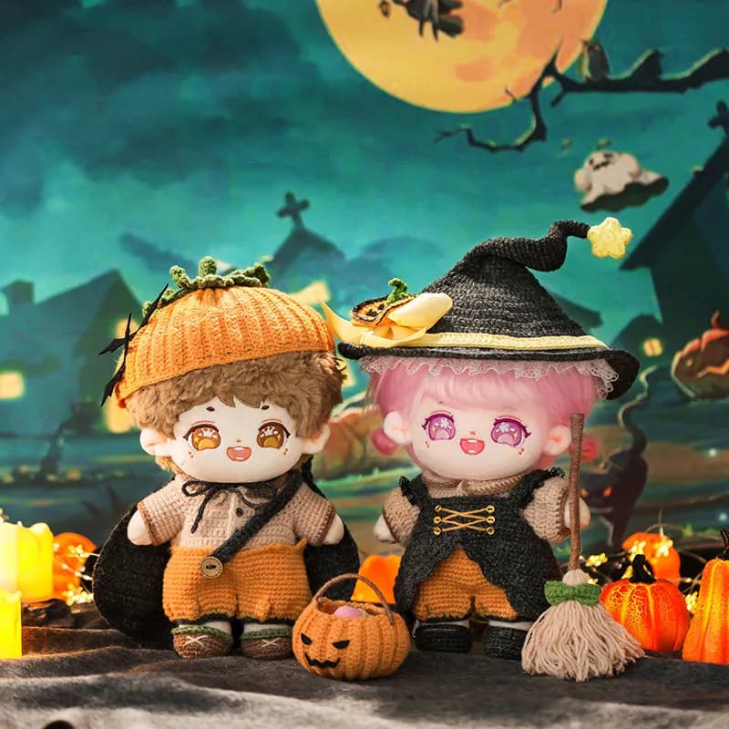 Dolls wearing crocheted witch and pumpkin outfits